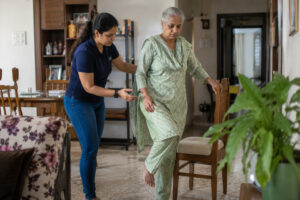 Elderly woman practicing balance exercise during home physiotherapy session